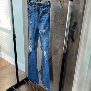 Indigo rein flared jeans with rips.